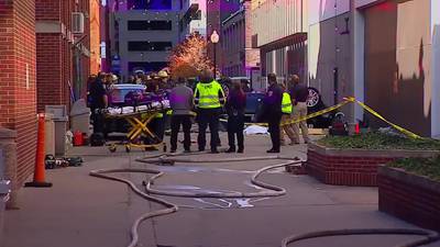 2 dead when vehicle plunges 4 stories from parking garage