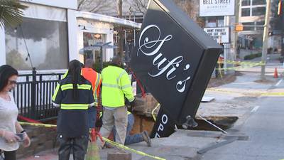 PHOTOS: Massive hole opens up along Peachtree Street