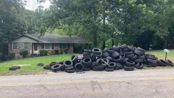 Metro Atlanta woman trapped in driveway after man dumps piles of tires on her property