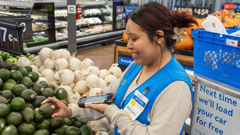 A Walmart worker scanning produce