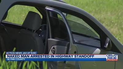 Naked man in custody after barricading himself in car on highway in Glynn County 
