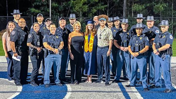 Officers stand in for father who died from COVID-19 complications as daughter graduates high school