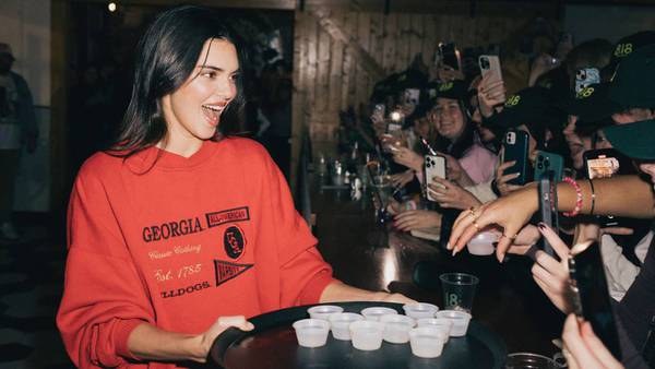 Kendall Jenner serves drinks to screaming crowd at Athens bars dressed in Bulldogs sweatshirt