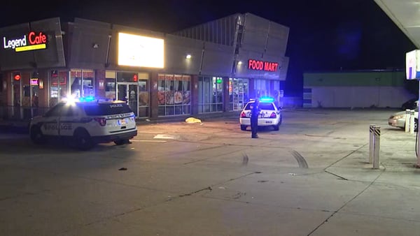 Man found shot to death in gas station parking lot; clerk says gunfire rang out at restaurant