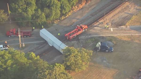 Tractor-trailer hauling cherries hit by train in Henry County