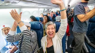 PHOTOS: Sir Richard Branson surprises some Delta flyers with free vacation