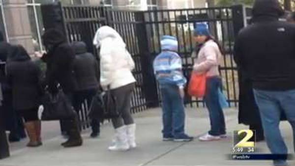 Parents, children wait hours in bitter cold for security screening