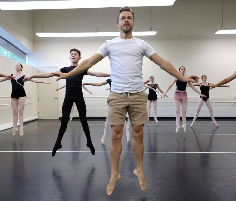 LAS VEGAS, NEVADA - AUGUST 13: Television personality and dancer Derek Hough (C) dances with students at the Academy of Nevada Ballet Theatre on August 13, 2022 in Las Vegas, Nevada. Hough made a surprise visit to a Teen/Senior Ballet class where he danced with students of various skill levels ranging in age from 13 to 18 years old as they practiced and talked to them about his experiences as a professional dancer, including his current headlining show "Derek Hough: No Limit" at The Venetian Resort Las Vegas. (Photo by Ethan Miller/Getty Images)