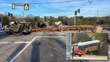 3 injured when school bus, truck collide, spilling logs across Georgia highway