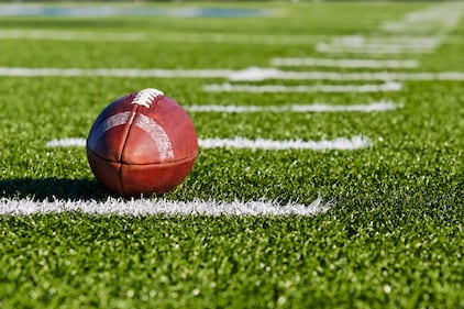 Football on Yardage Marker. Low Angle. Horizontial View