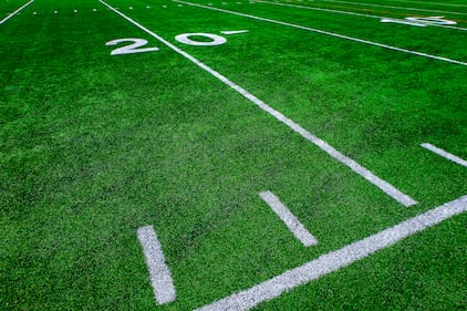 Football field green grass white yard markers to touchdown competition game