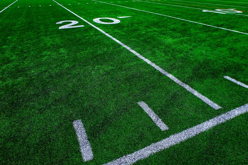 Football field green grass white yard markers to touchdown competition game