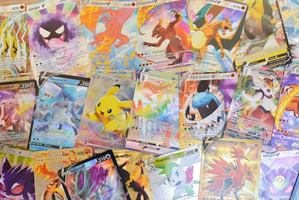 Arahal. Seville. Spain. 1st March 2023. Background created with collectible Pokemon cards on a wooden board. Collectible trading cards based on the Pokemon children's anime series.