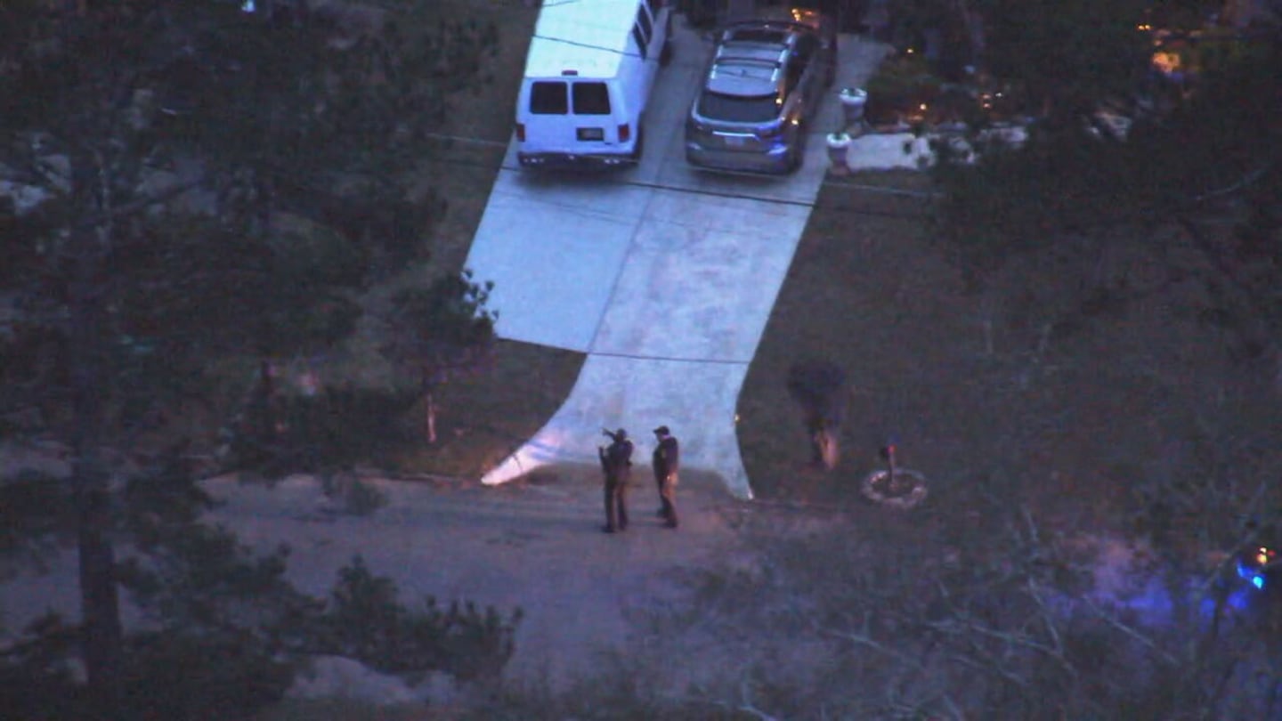 Aerial view shows two officers at the end of a driveway in DeKalb County.