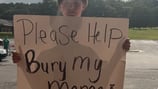 11-year-old Georgia boy holds up heartbreaking sign asking for help to bury his mom