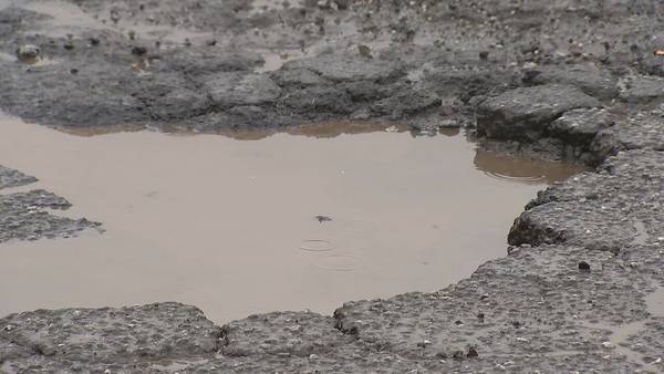 Residents concerned about road littered with potholes